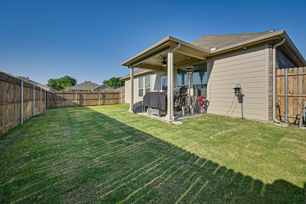10621 Alpine Meadow Lane Fort Worth, TX 76140 - Photo 33 of 35 a view of a house with a yard and a table and chairs
