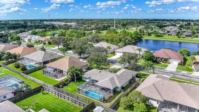 an aerial view of residential houses with outdoor space and street view