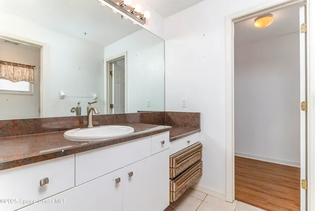 a view of a kitchen with wooden cabinet and a ceiling fan