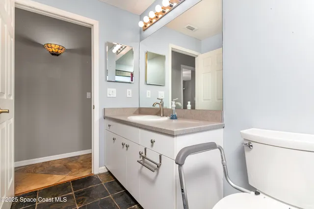 a view of an empty room and window with a ceiling fan