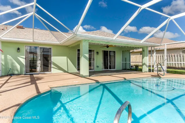 a view of an house with swimming pool and porch