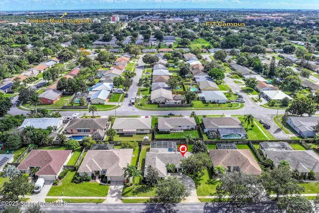 an aerial view of residential houses with outdoor space and swimming pool