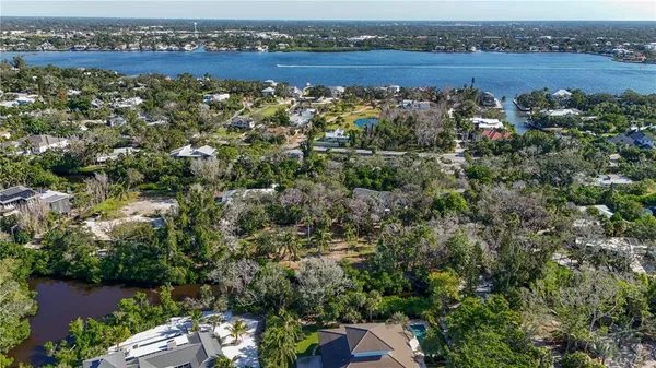 an aerial view of a house with a yard and lake view