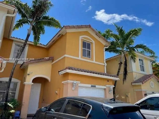 a front view of residential houses with parking space