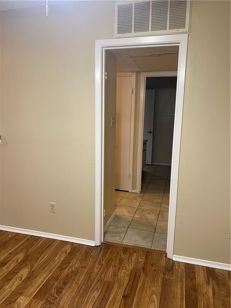 806 West 24th Street, Unit 308 Austin, TX 78705 - Photo 16 of 25 an empty room with wooden floor and a hallway