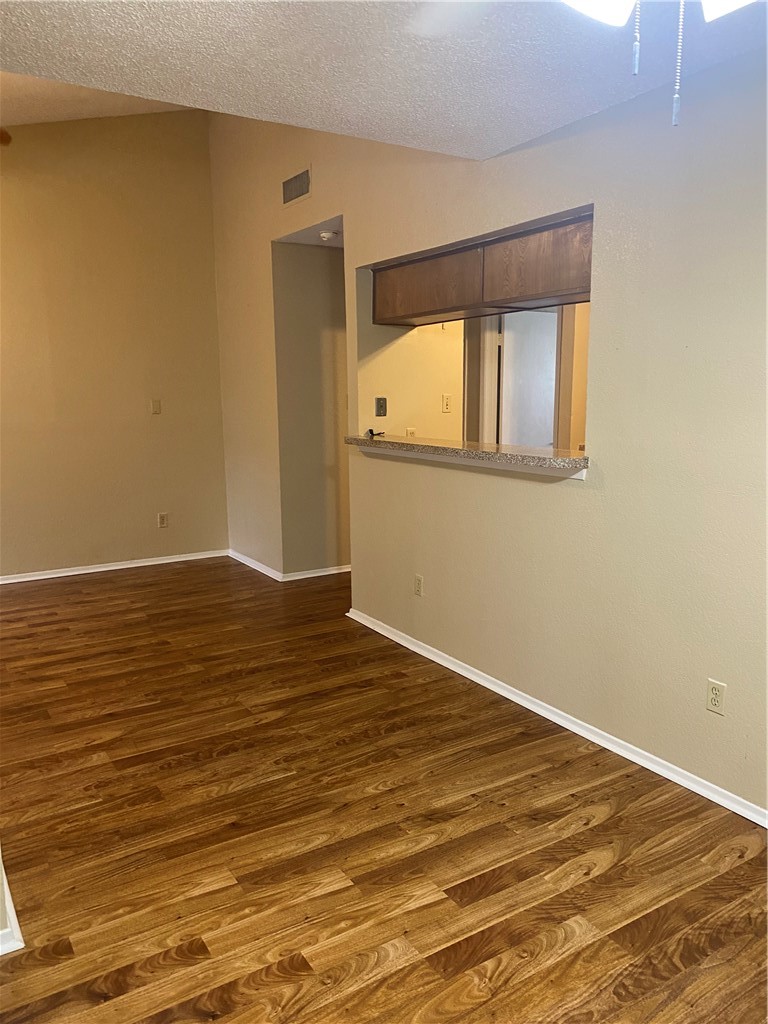 806 West 24th Street, Unit 308 Austin, TX 78705 - Photo 20 of 25 a view of an empty room with wooden floor and a window