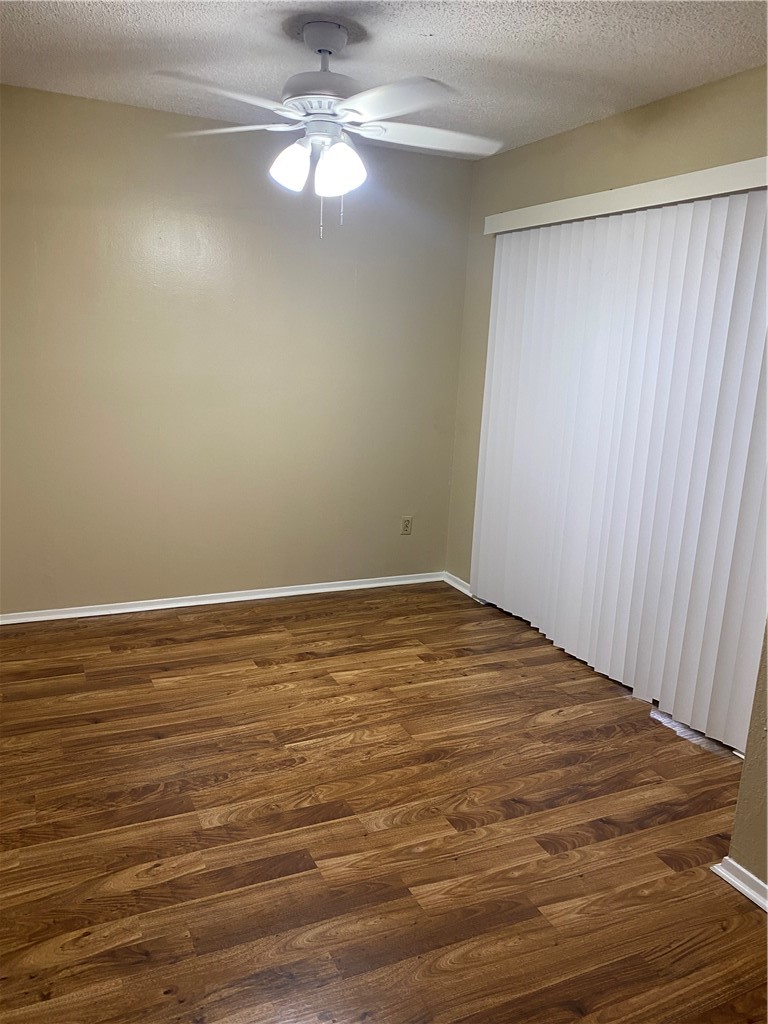 806 West 24th Street, Unit 308 Austin, TX 78705 - Photo 21 of 25 an empty room with wooden floor fan and window