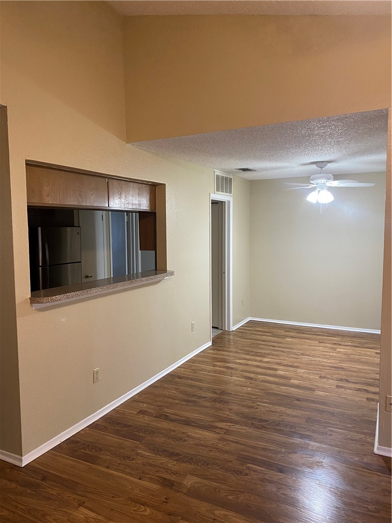 806 West 24th Street, Unit 308 Austin, TX 78705 - Photo 5 of 25 a view of an empty room with wooden floor and a window