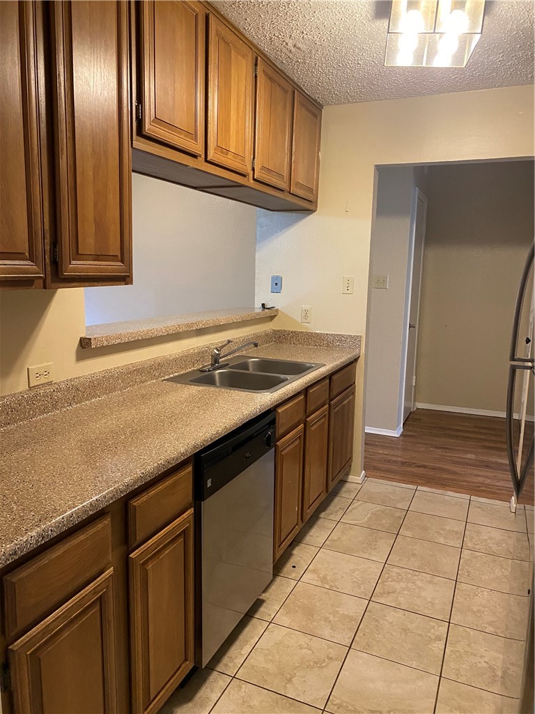 806 West 24th Street, Unit 308 Austin, TX 78705 - Photo 6 of 25 a kitchen with stainless steel appliances granite countertop a sink stove and cabinets
