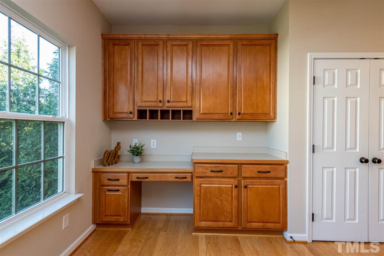 3501 Weir Way Raleigh, NC 27616 - Photo 14 of 30 a room with wooden cabinets and a window