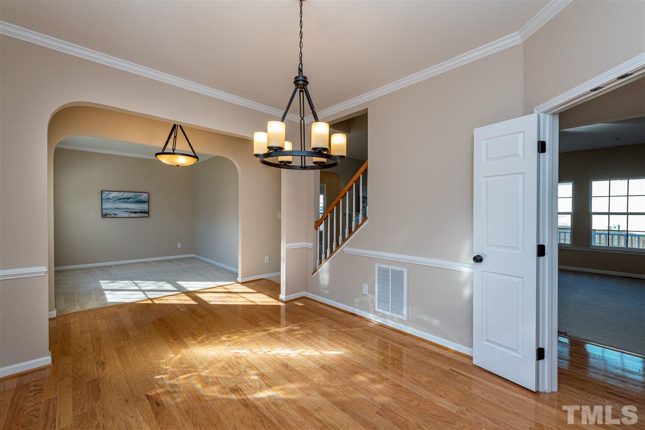 3501 Weir Way Raleigh, NC 27616 - Photo 4 of 30 a view of a livingroom with wooden floor and a chandelier