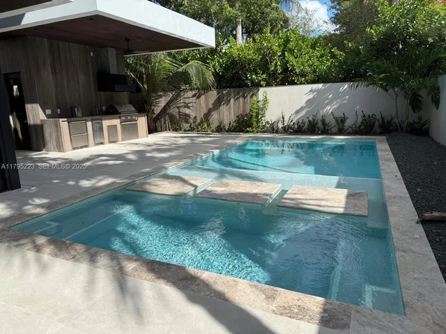 a bedroom with a bed and a night stand