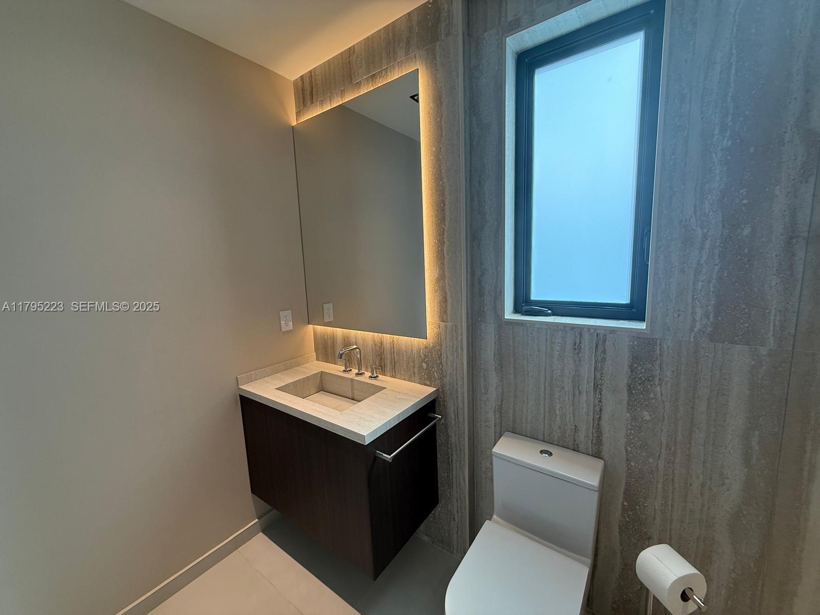 125 Southwest 29th Road Miami, FL 33129 - Photo 36 of 44 a bathroom with a toilet sink vanity and mirror