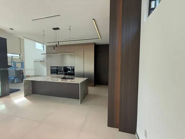 a large white kitchen with a large window