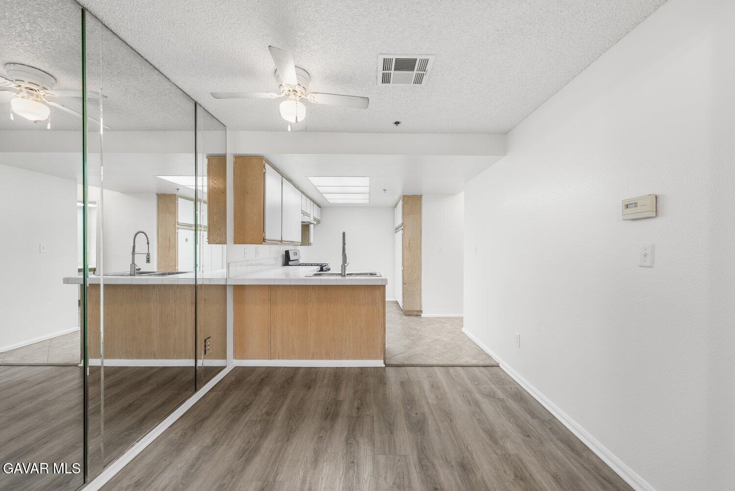 44526 15th Street East, Unit 4 Lancaster, CA 93535 - Photo 12 of 52 a view of kitchen with sink and wooden floor