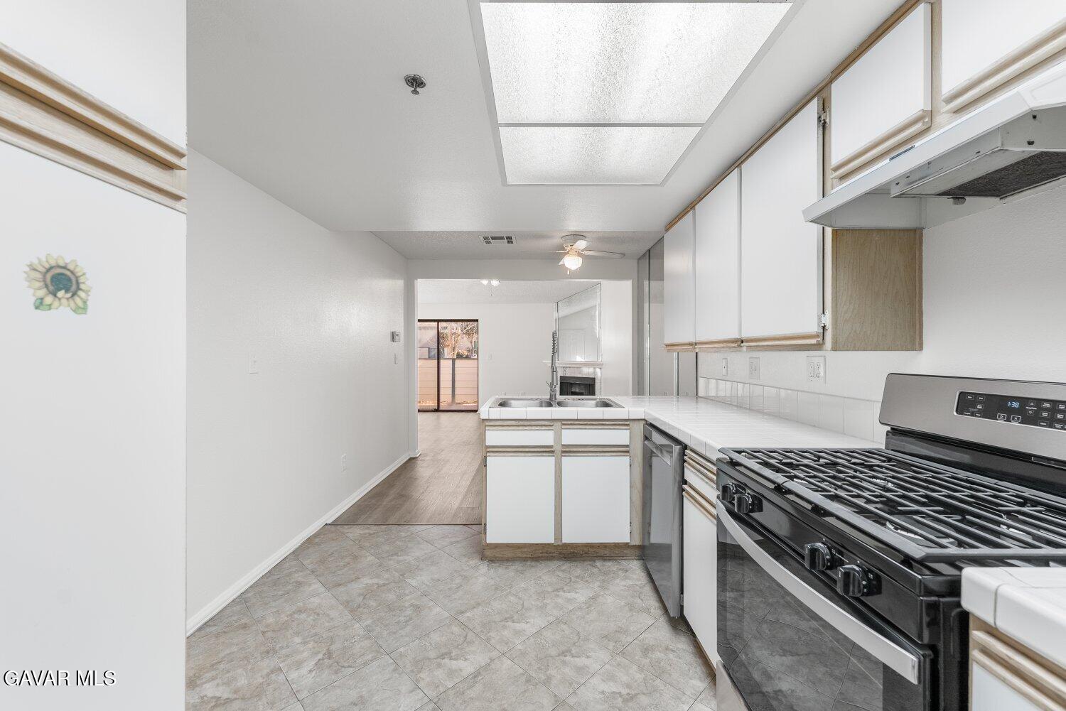 44526 15th Street East, Unit 4 Lancaster, CA 93535 - Photo 20 of 52 a kitchen with a sink stove and cabinets