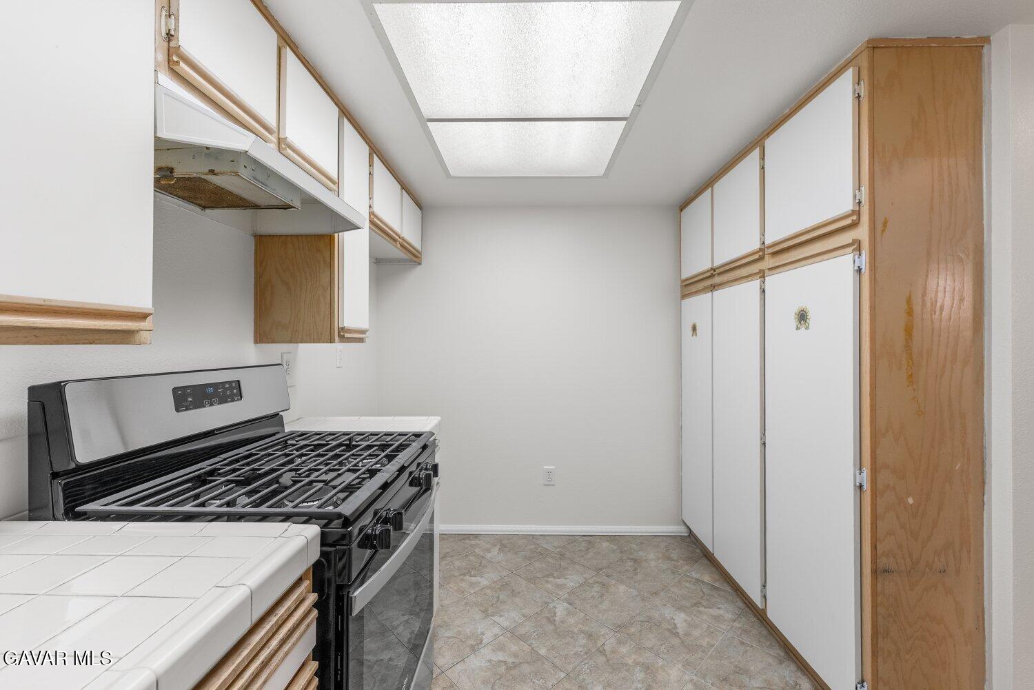 44526 15th Street East, Unit 4 Lancaster, CA 93535 - Photo 22 of 52 a kitchen with stainless steel appliances granite countertop a stove and a refrigerator