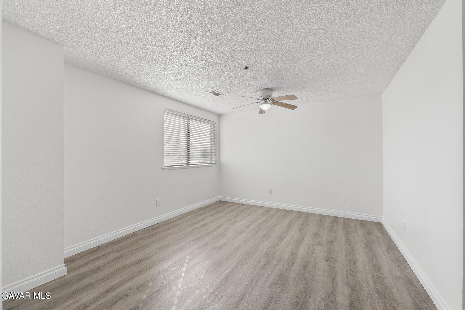 44526 15th Street East, Unit 4 Lancaster, CA 93535 - Photo 27 of 52 an empty room with wooden floor and windows