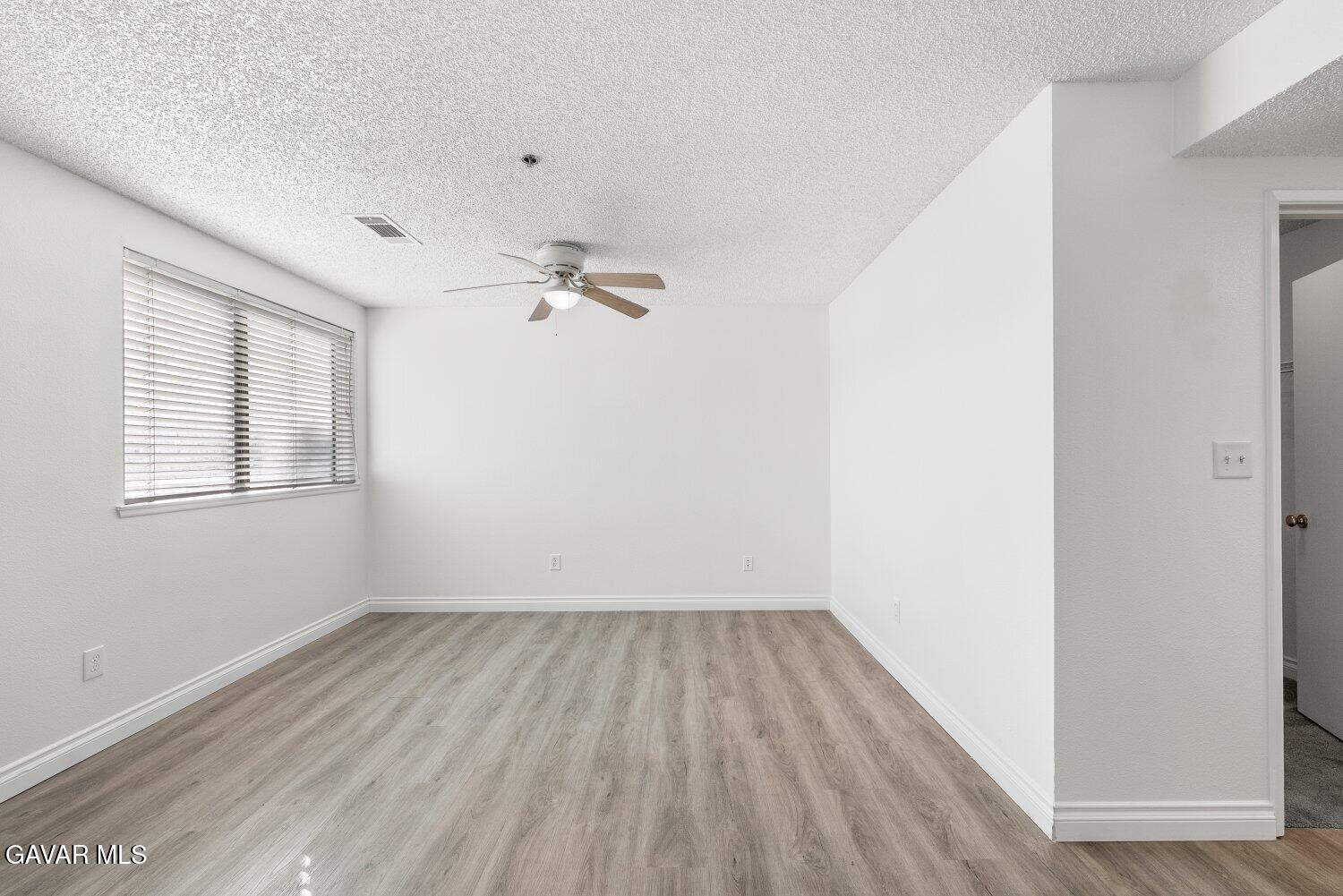 44526 15th Street East, Unit 4 Lancaster, CA 93535 - Photo 28 of 52 a view of room with hardwood floor and window