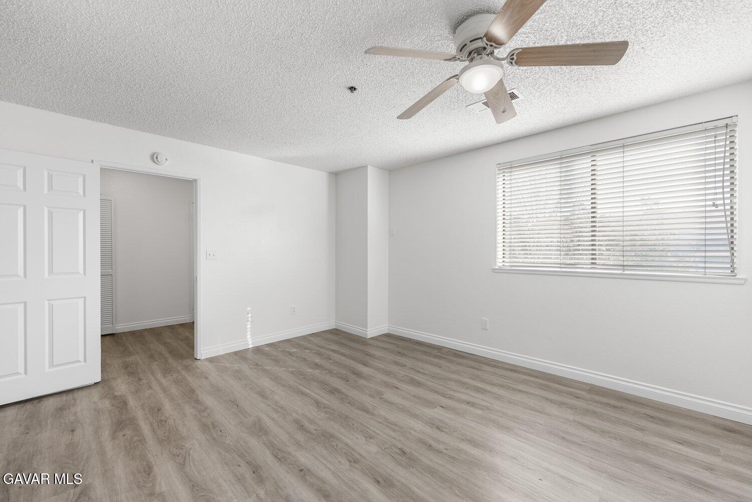 44526 15th Street East, Unit 4 Lancaster, CA 93535 - Photo 31 of 52 wooden floor in an empty room with a window