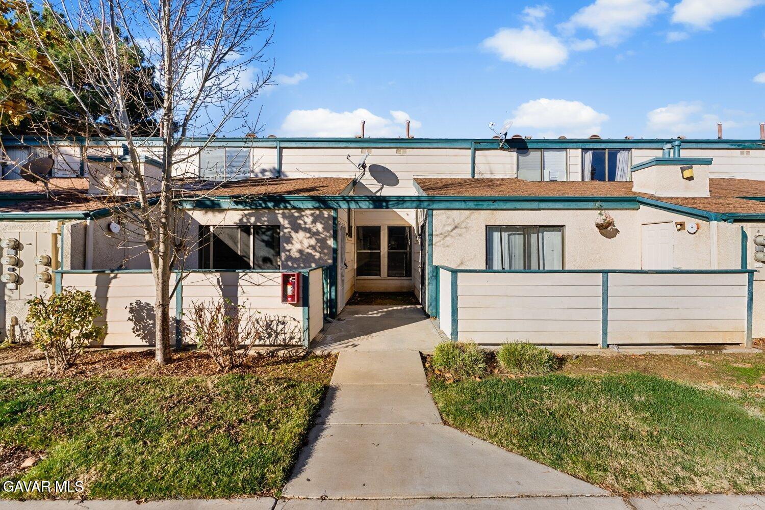 44526 15th Street East, Unit 4 Lancaster, CA 93535 - Photo 43 of 52 front view of a house with a garden