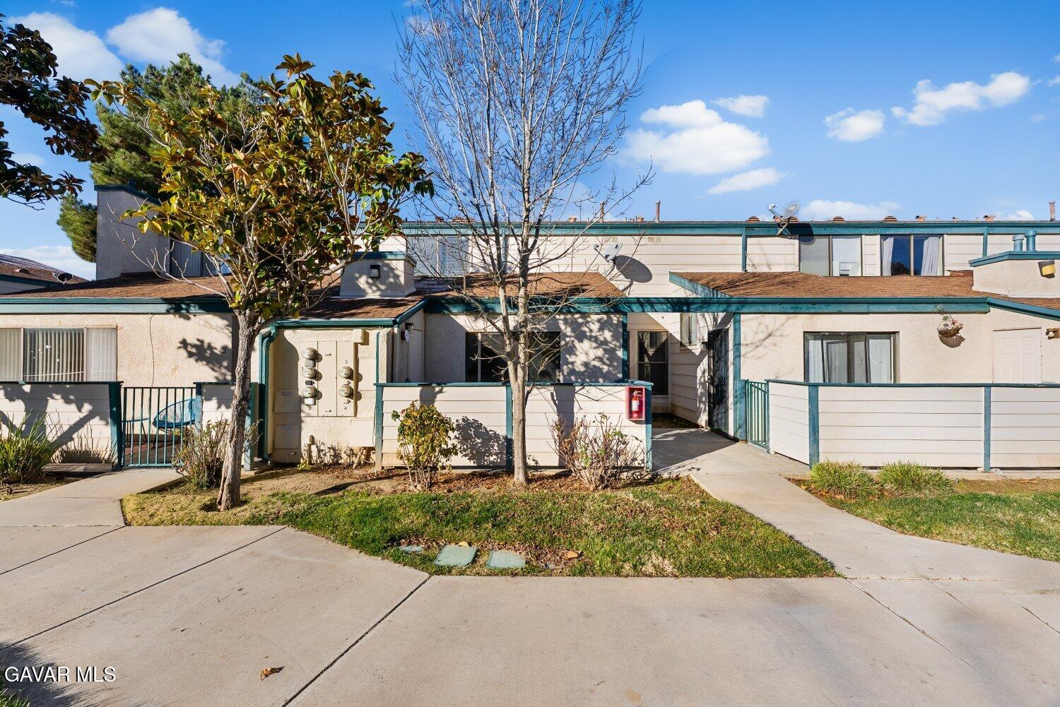 44526 15th Street East, Unit 4 Lancaster, CA 93535 - Photo 44 of 52 a front view of a house with a yard
