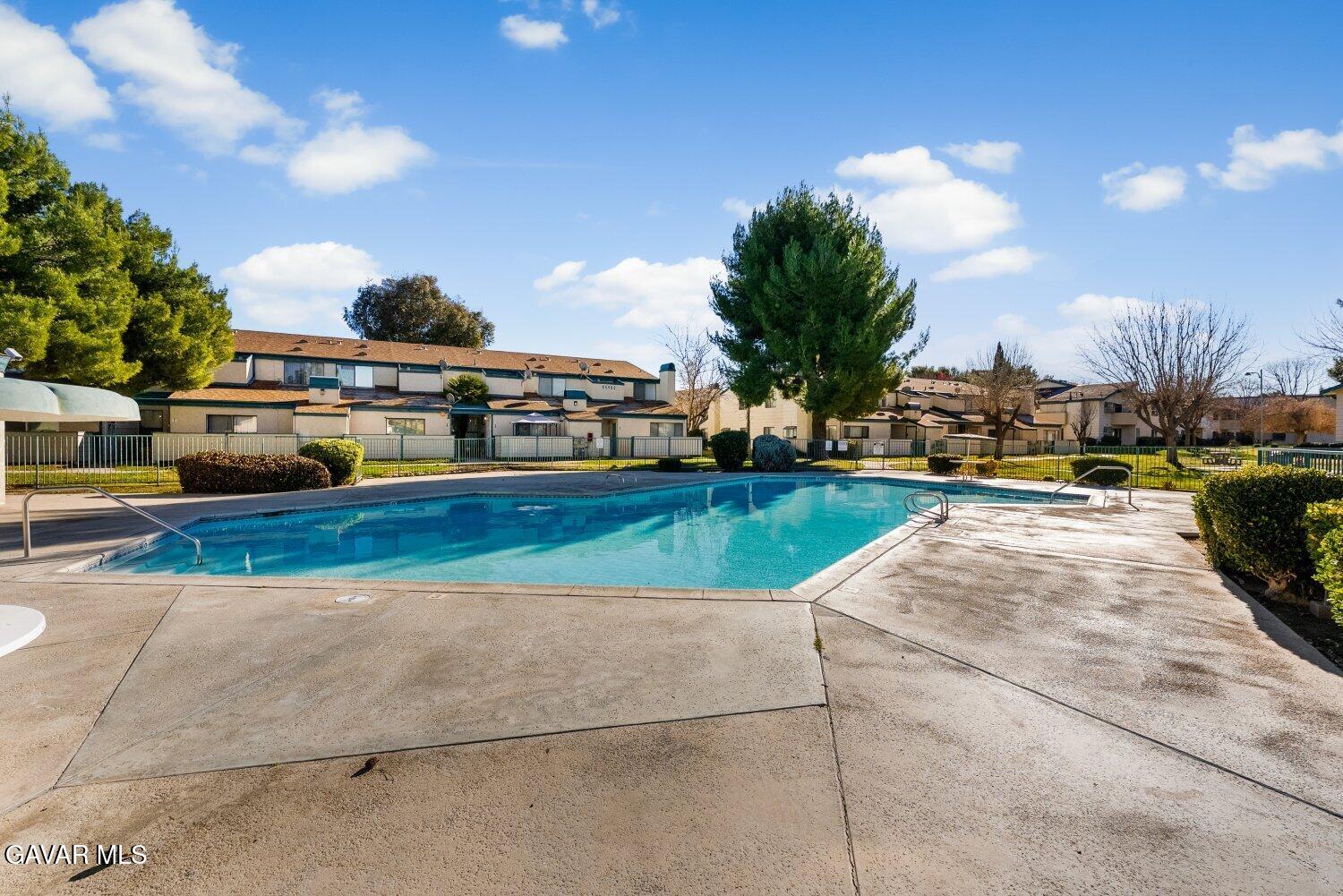 44526 15th Street East, Unit 4 Lancaster, CA 93535 - Photo 45 of 52 a view of a swimming pool with a yard