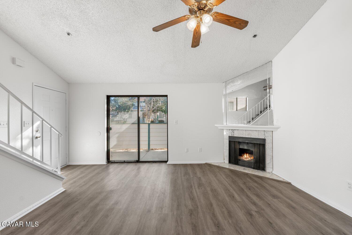 44526 15th Street East, Unit 4 Lancaster, CA 93535 - Photo 5 of 52 a view of an empty room with wooden floor and a window