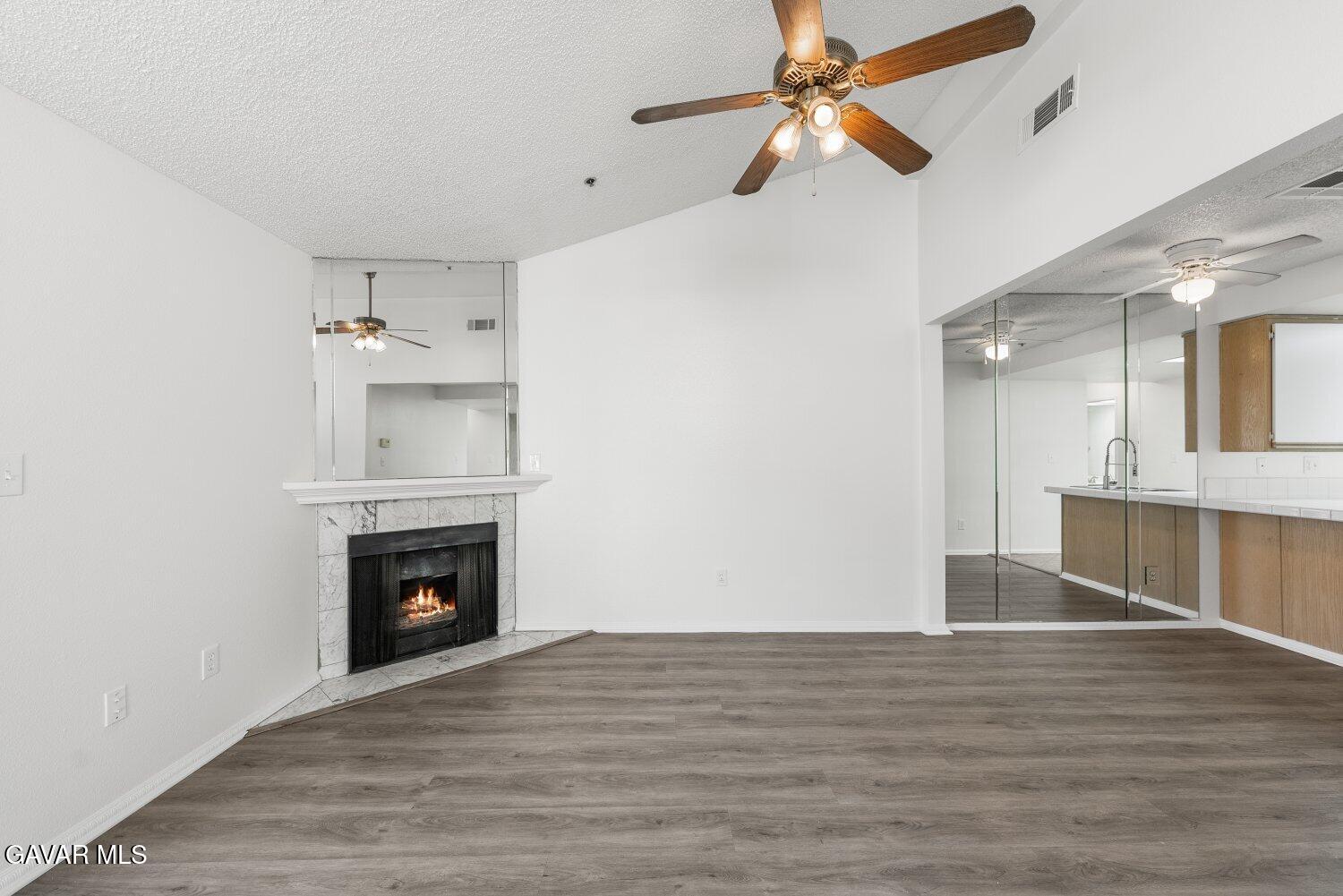 44526 15th Street East, Unit 4 Lancaster, CA 93535 - Photo 10 of 52 a view of empty room with wooden floor and fireplace