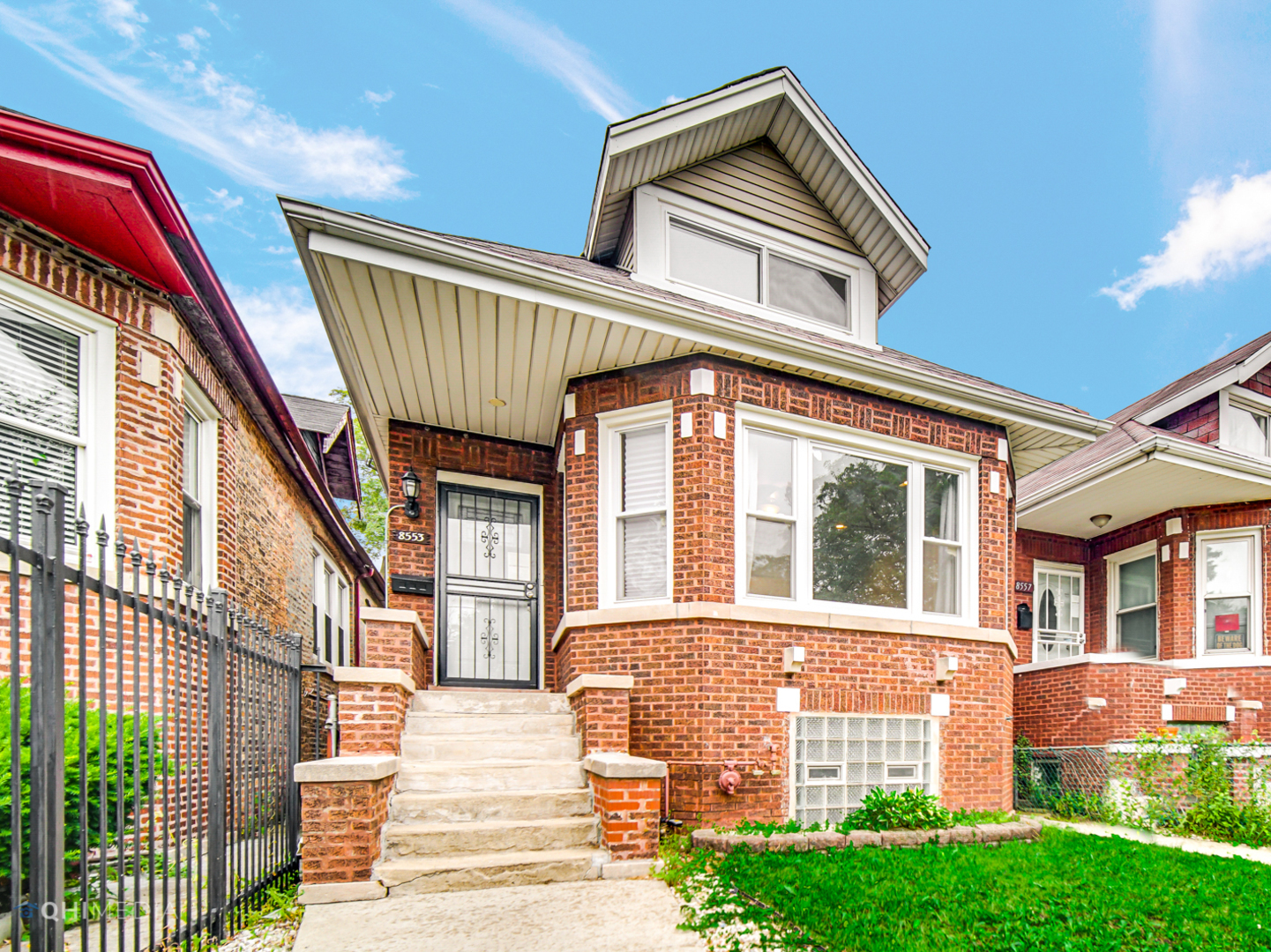 8553 South Sangamon Street Chicago, IL 60620 - Photo 1 of 27 a front view of a house with a yard