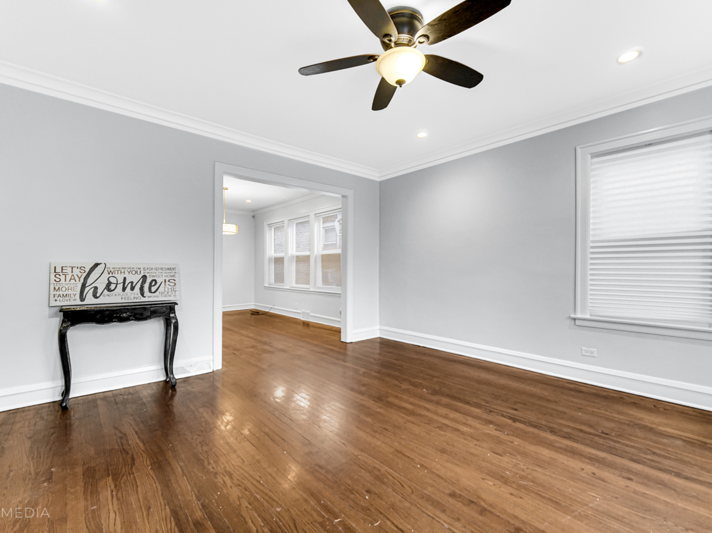 8553 South Sangamon Street Chicago, IL 60620 - Photo 11 of 27 a view of an empty room with wooden floor and a window