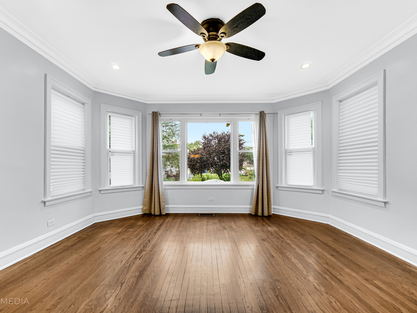8553 South Sangamon Street Chicago, IL 60620 - Photo 12 of 27 a view of an empty room with wooden floor and a window
