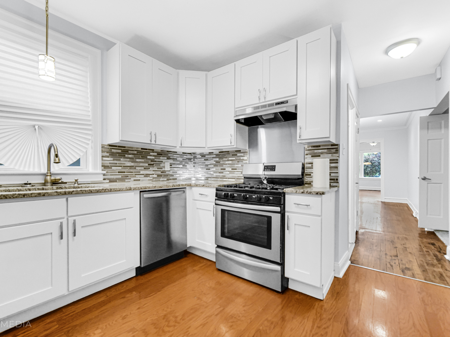8553 South Sangamon Street Chicago, IL 60620 - Photo 14 of 27 a kitchen with granite countertop white cabinets and appliances