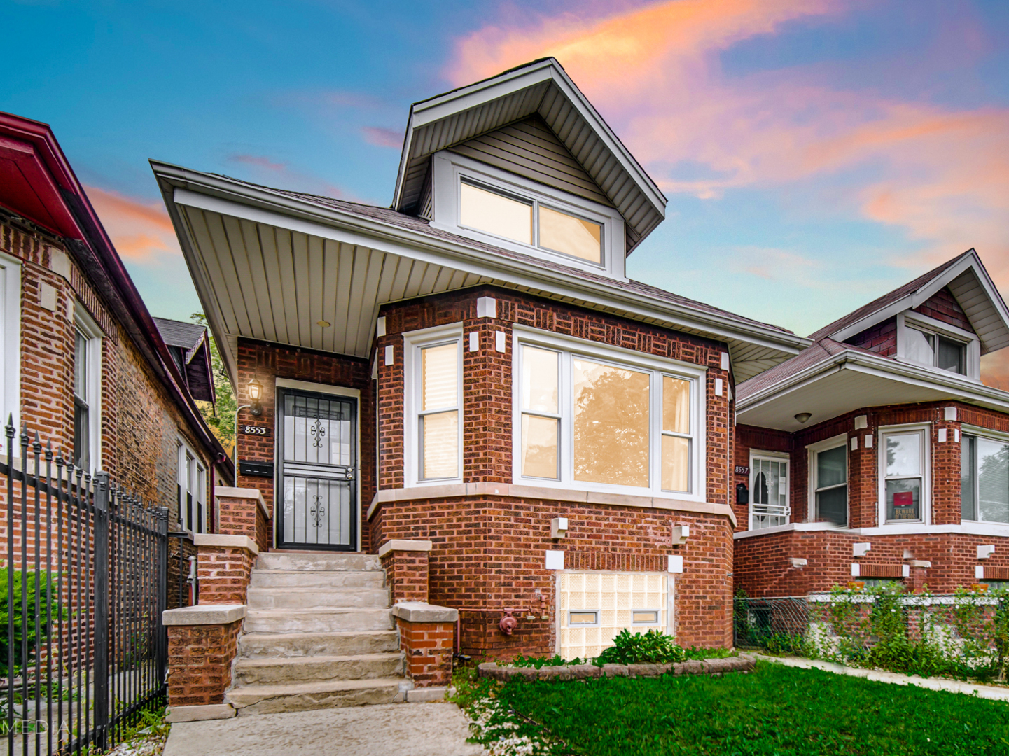 8553 South Sangamon Street Chicago, IL 60620 - Photo 2 of 27 a front view of a house with a yard
