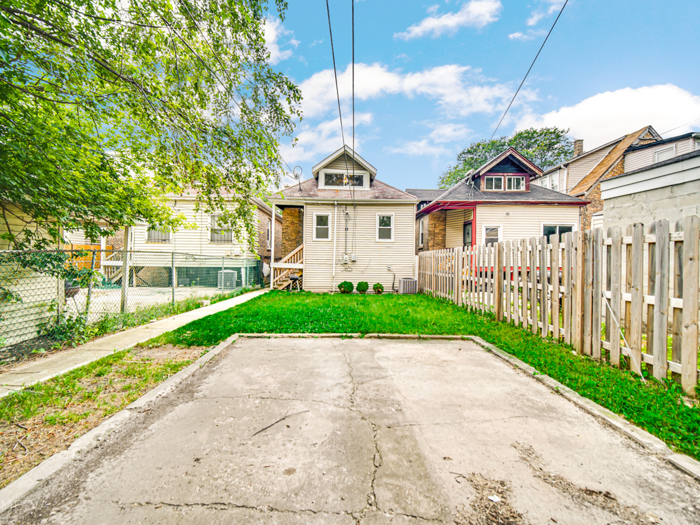 8553 South Sangamon Street Chicago, IL 60620 - Photo 23 of 27 a view of a house with a small yard and wooden fence