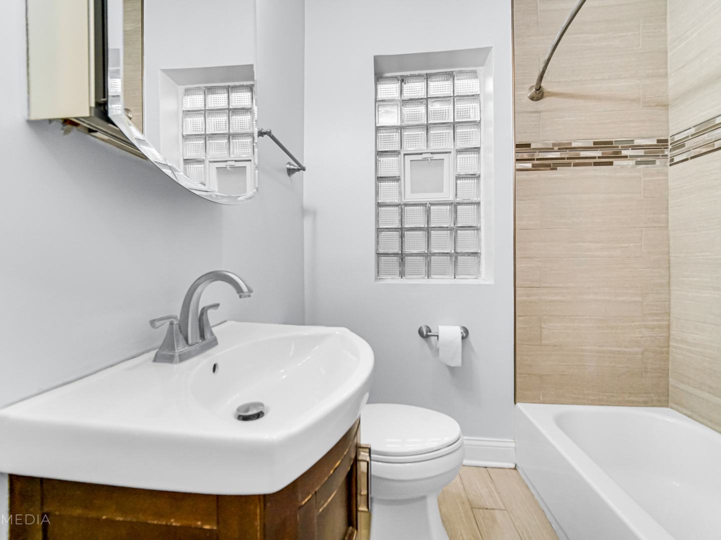 8553 South Sangamon Street Chicago, IL 60620 - Photo 6 of 27 a bathroom with a sink a toilet and shower