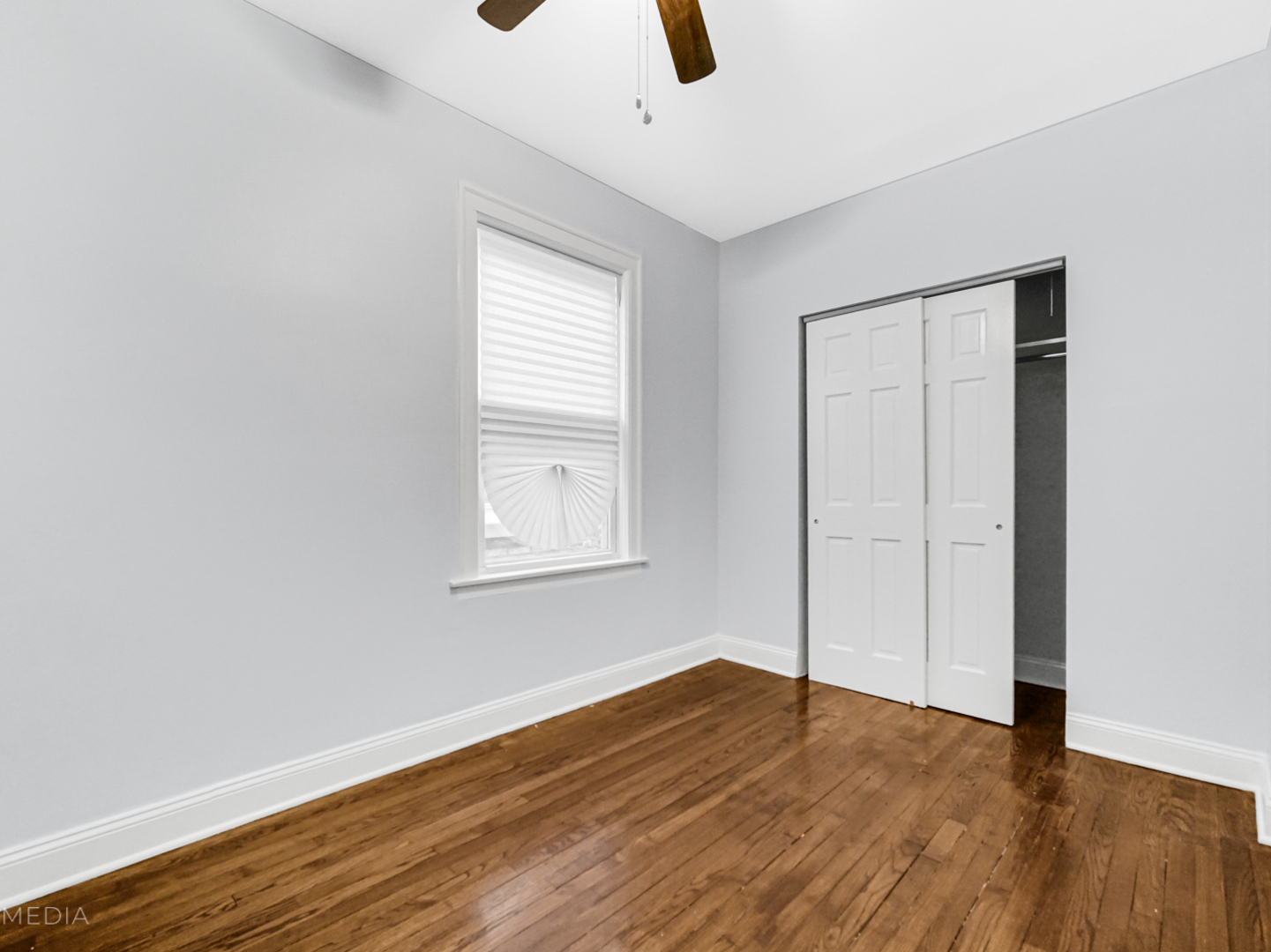 8553 South Sangamon Street Chicago, IL 60620 - Photo 7 of 27 an empty room with wooden floor cabinet and windows