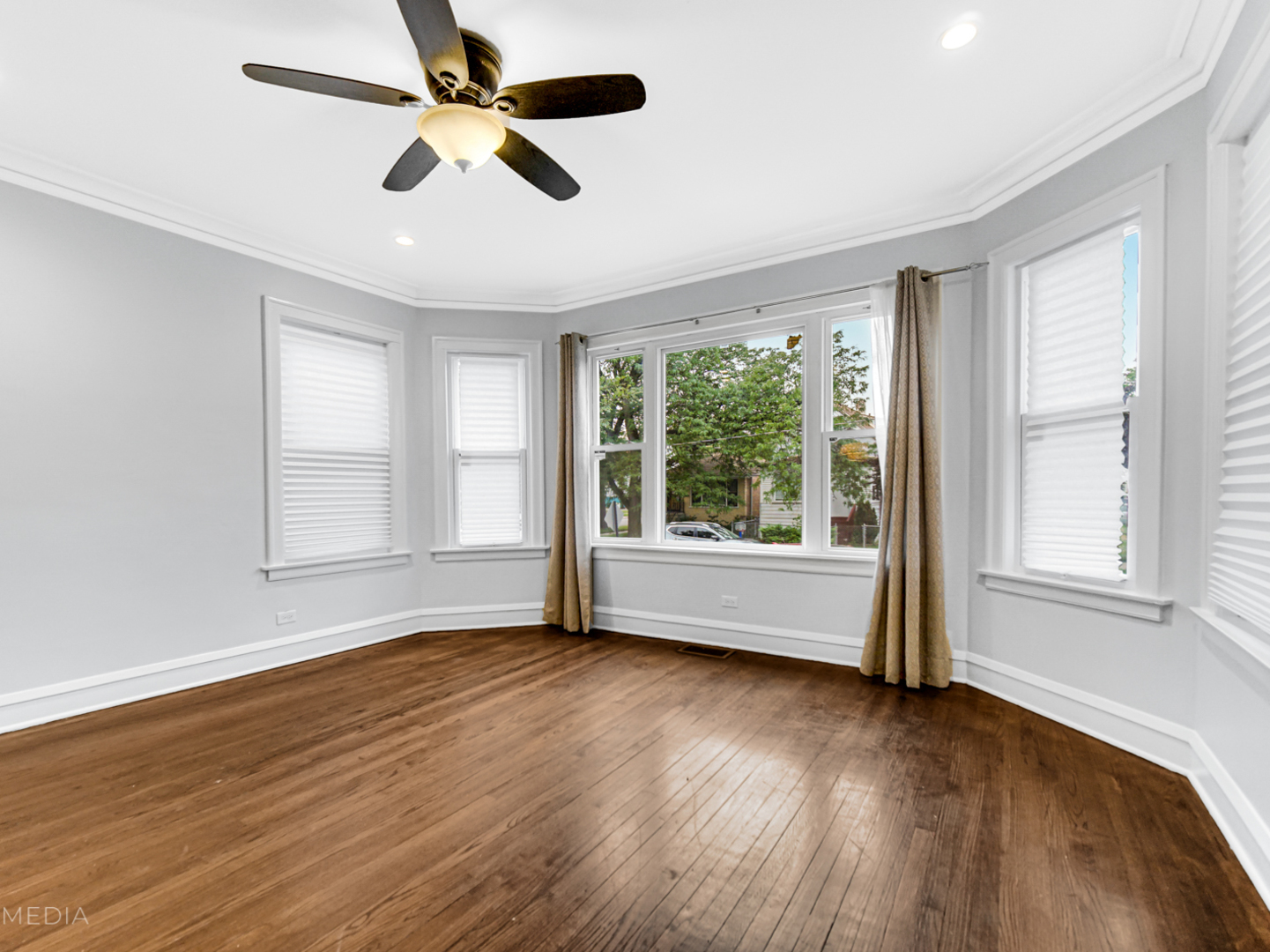 8553 South Sangamon Street Chicago, IL 60620 - Photo 9 of 27 a view of an empty room with wooden floor and a window