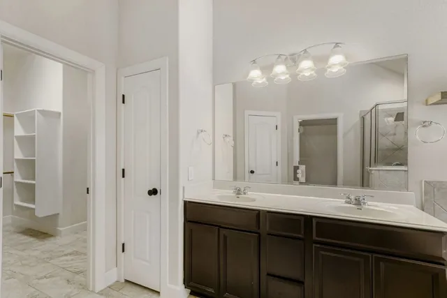 a bathroom with a double vanity sink mirror and double