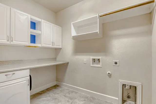 a view of storage and utility room with closet