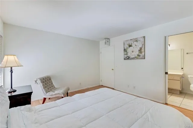 a bedroom with a bed and a lamp