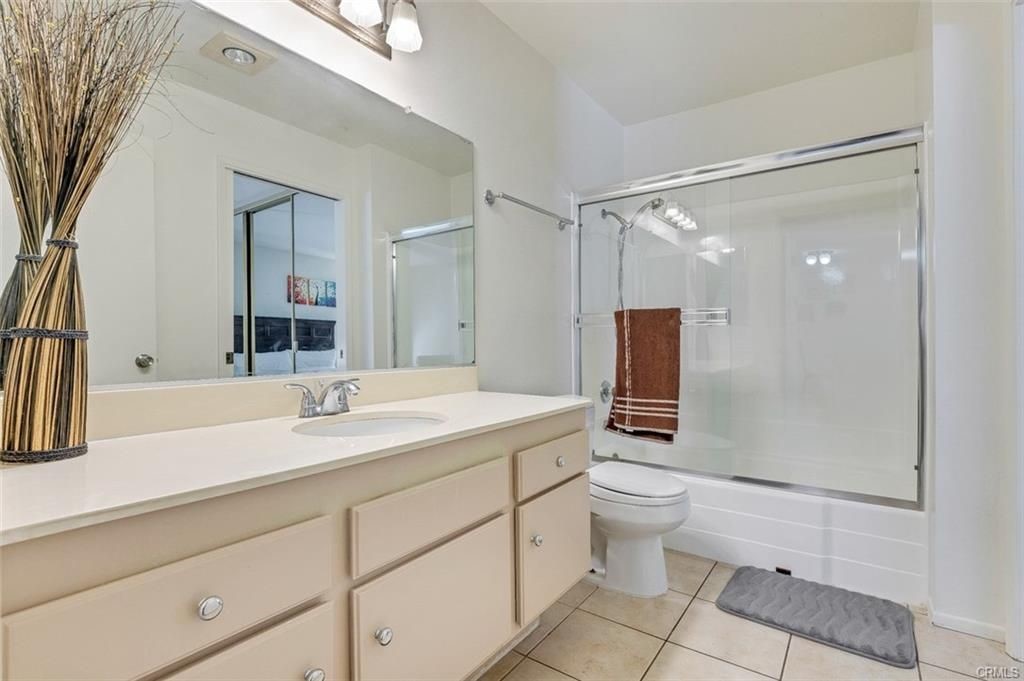 424 Orange Blossom, Unit 204 Irvine, CA 92618 - Photo 5 of 6 a bathroom with a sink a toilet a mirror and shower