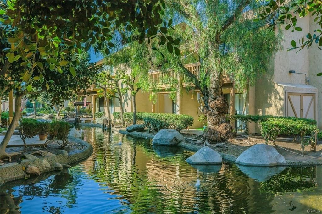 424 Orange Blossom, Unit 204 Irvine, CA 92618 - Photo 6 of 6 a view of a house with swimming pool garden and patio