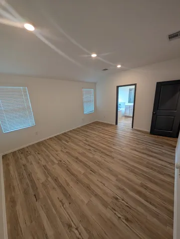 a kitchen with granite countertop a sink a counter top space cabinets and stainless steel appliances