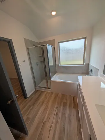 a view of a large kitchen with a sink and dishwasher with wooden floor