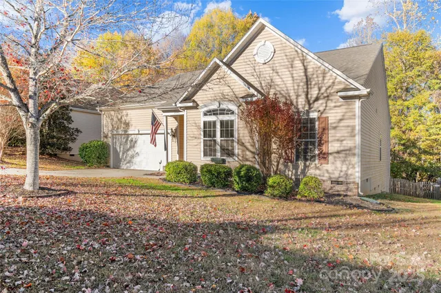 a view of a house with a yard and pathway