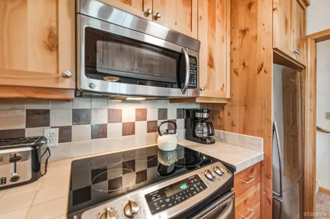 a kitchen with stainless steel appliances granite countertop a stove and a microwave