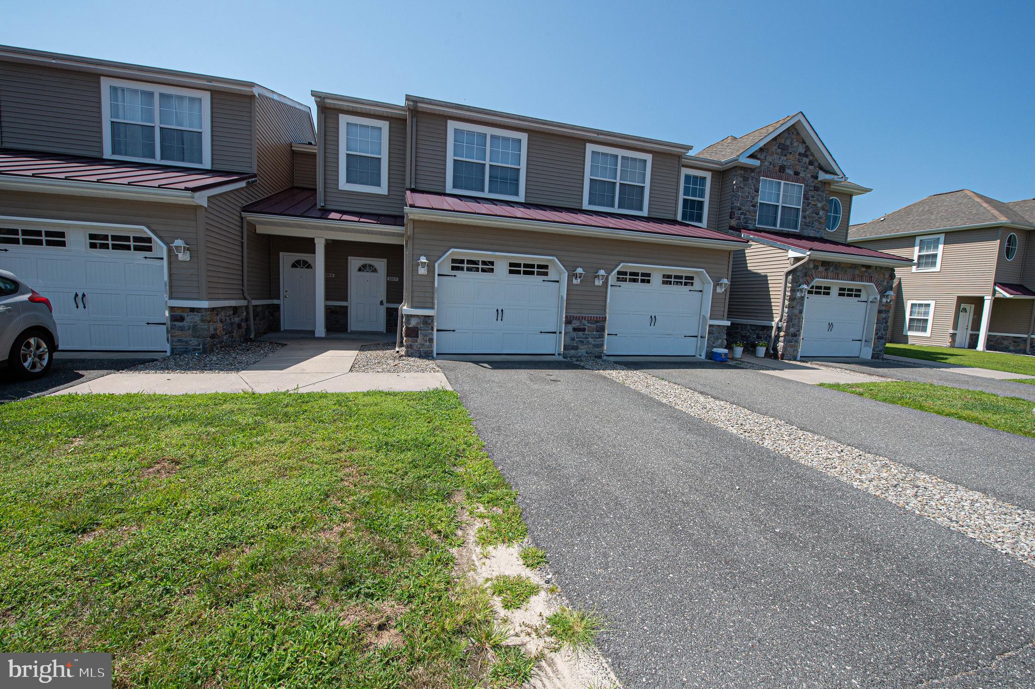 420 Parkview Court, Unit F Salisbury, MD 21804 - Photo 1 of 87 a front view of a building with a garden and parking space