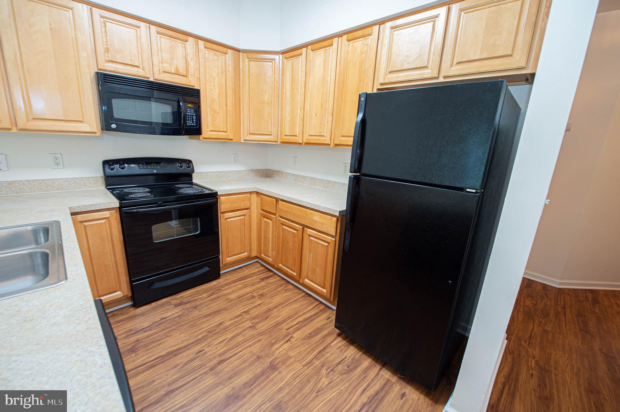 420 Parkview Court, Unit F Salisbury, MD 21804 - Photo 25 of 87 a kitchen with a refrigerator stove and microwave
