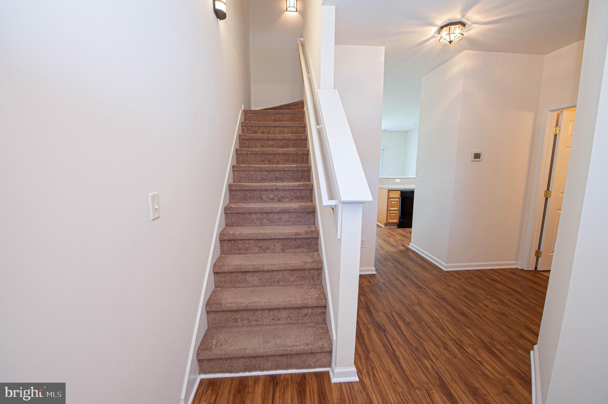 420 Parkview Court, Unit F Salisbury, MD 21804 - Photo 47 of 87 a view of a hallway with wooden floor and staircase